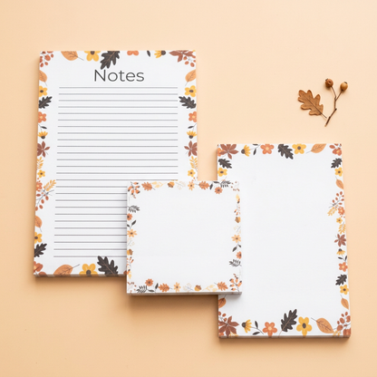 Leaves and acorns border stationery on a light peach background