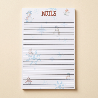 Individual snowman and snowflakes notepad on a soft cream background