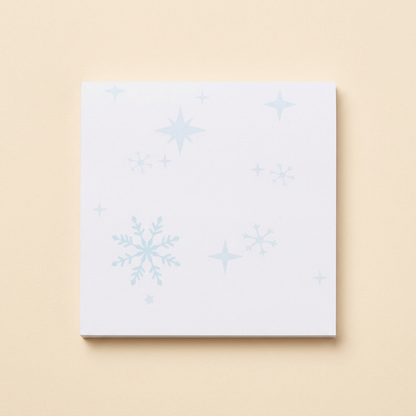 Snowflake sticky notes on a soft cream background
