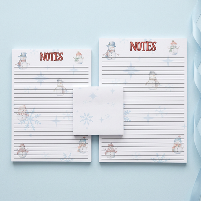 Snowman and snowflakes stationery on a pale icy-blue background