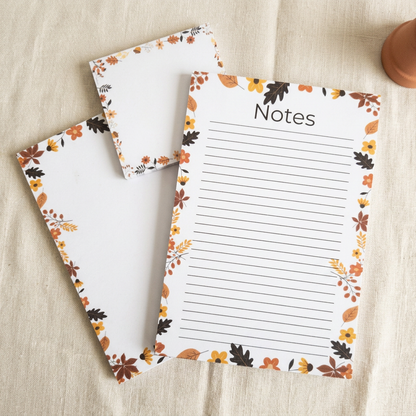 Leaves and acorns border stationery styled on cream linen