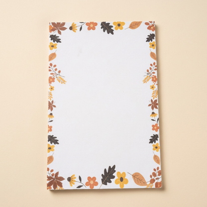 Leaves and acorns unlined notepad on a soft cream background